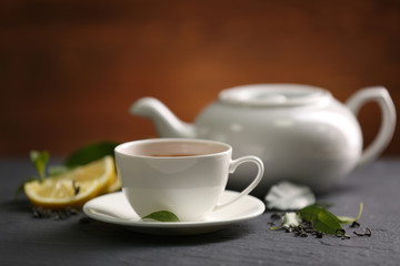 Cup of tea and teapot on table