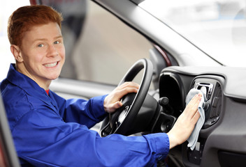 Fototapeta na wymiar Young man polishing vehicle interior