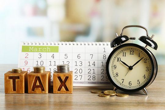 Tax Time And Alarm Clock With Coins And Calendar