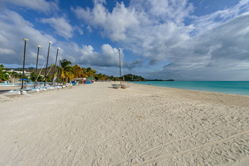 Tropical beach at Antigua island in Caribbean with white sand, t
