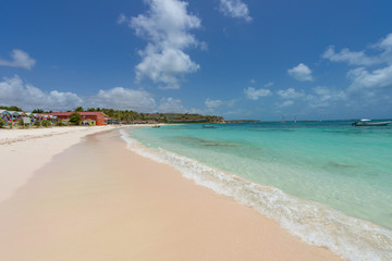 Tropical beach at Antigua island in Caribbean with white sand, t