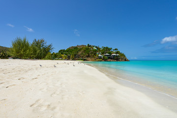 Tropical beach at Antigua island in Caribbean with white sand, t