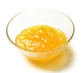 Sweet melon jam in the transparent glass bowl with honey