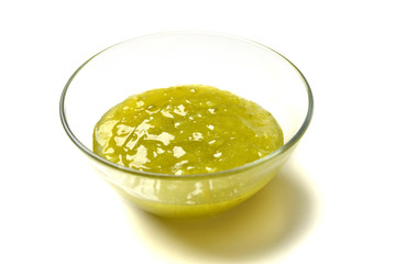 Sweet lime and apple jam in the transparent glass bowl with hone