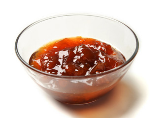 Sweet cherry-plum jam in the transparent glass bowl