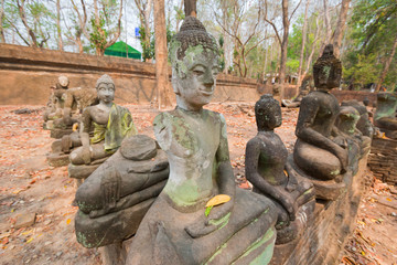 The old Buddha statue and moss at Tunnel Temple (Wat U-mong), Chiang Mai Province, Northern Thailand
