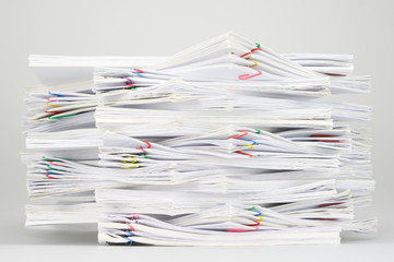 Overload document with colorful paperclip on white table