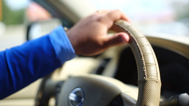 Man manages the car steering wheel