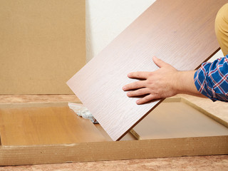 Man opens box with furniture