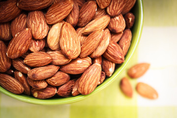 Almonds in green bowl.