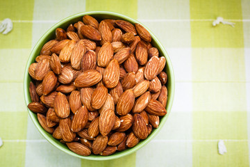 Almonds in green bowl.