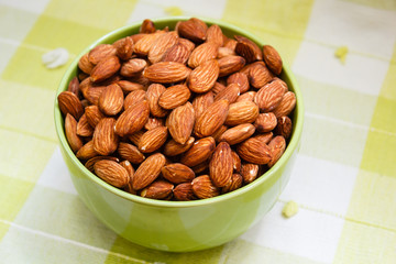 Almonds in green bowl.