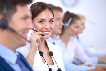 Attractive Smiling positive young businesspeople and colleagues in a call center office