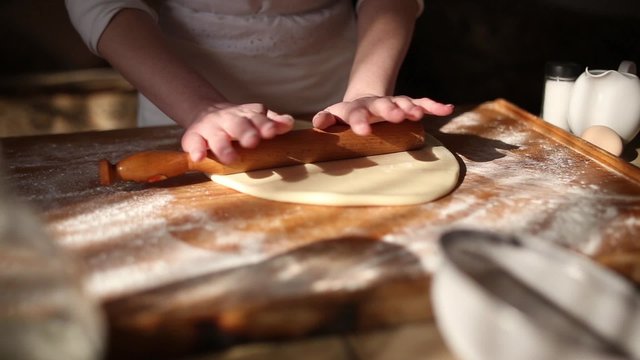 Rolling dough with rolling pin for baking
