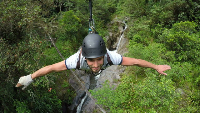 Experience the thrill of adult men riding a zipline captured by a cable mounted camera in stunning footage.