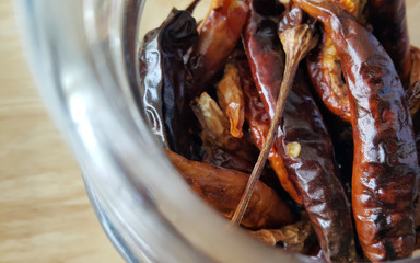 Top view of dried chili in a glass bottle with space for text