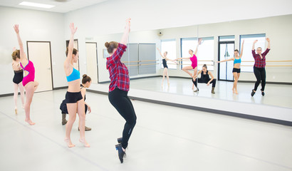 group of young dancers practicing in front of mirror