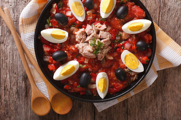 Arabic Mechouia salad with vegetables, tuna and eggs closeup. horizontal top view
