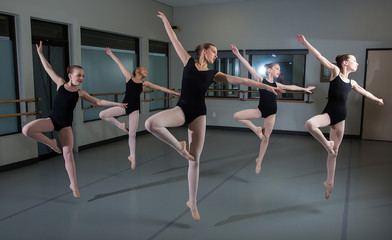 Fototapeta na wymiar Group of ballet dancers jumping in the air