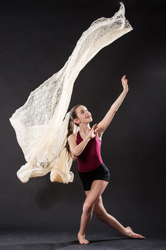 Portrait of young ballet dancer with flying lace