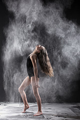 Fototapeta na wymiar Black and white portrait of strong teenage dancer with white pow