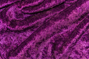 Fototapeta na wymiar The texture, background draped purple velvet fabric