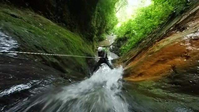 Experience the thrill of canyoning as our expert instructor guides you through rappelling down a stunning waterfall with audio footage to enhance the adventure.