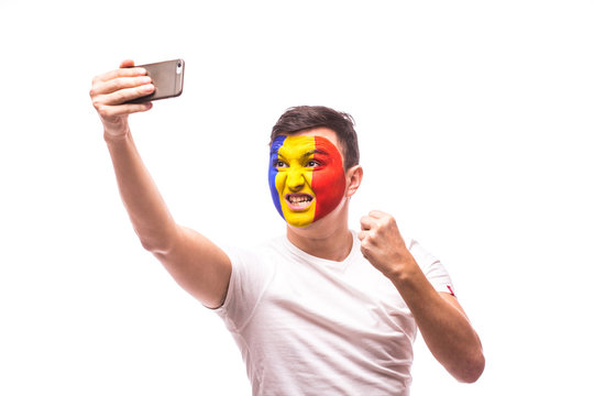 Romanian football fan take selfie photo with phone on white background. European 2016 football fans concept.