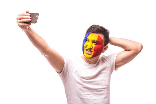 Romanian football fan take selfie photo with phone on white background. European 2016 football fans concept.