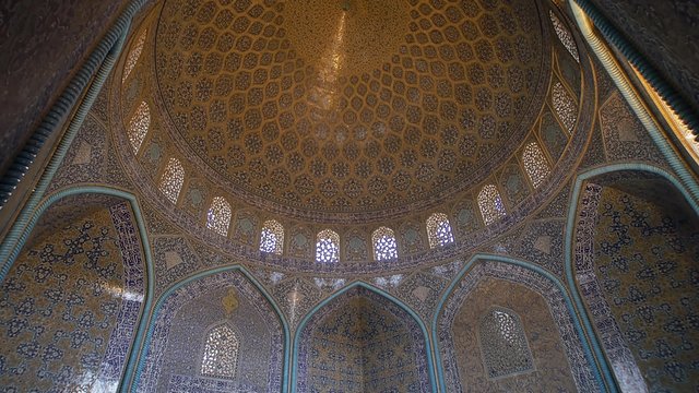 Sheikh Lotfollah Mosque beautiful interior decorated with colorful mosaic, paning from the floor to the breathtaking dome, Isfahan Iran.