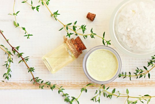 Aroma oil, facial cream, sea salt. Fresh thyme herbs. Herbal remedies. 