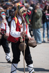 Paisievo, Bulgaria - March 26, 2016: People in costumes are taking part in the festival of Mummers in Paisievo, Bulgaria. Games, dances and activities are organized for viewers.