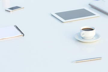 Side View of White Table with Electronics and Stationary