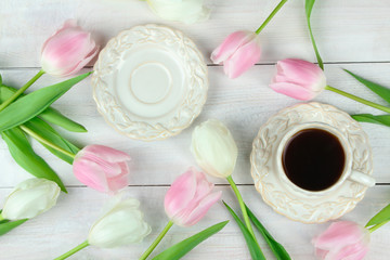 beautiful pink and white tulips laid on wooden background with Cup of coffee