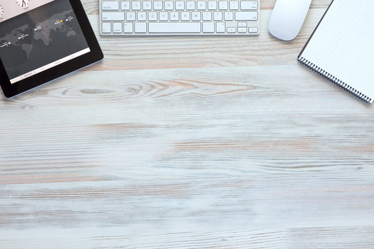 Composition with modern Electronics and Stationery Items in Wood Background