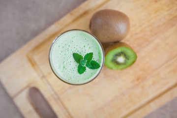 Summer cocktail of kiwi fruit and ice cream on a wooden background