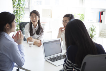 Four of the women, have a meeting in the office