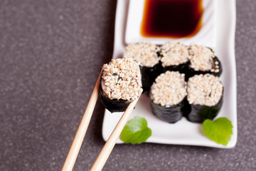 Sushi with sesame on a white plate