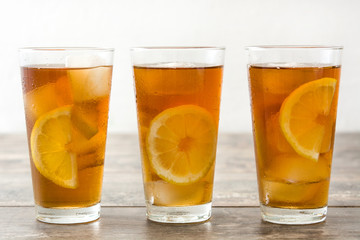 refreshing iced tea with lemon on wood