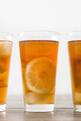 refreshing iced tea with lemon on wood