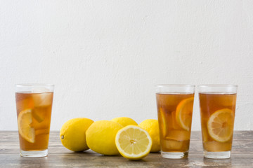 refreshing iced tea with lemon on wood