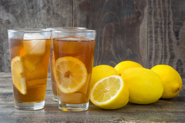 refreshing iced tea with lemon on wood