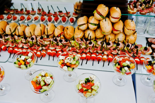 Buffet table of reception with burgers, cold snacks, meat and sa