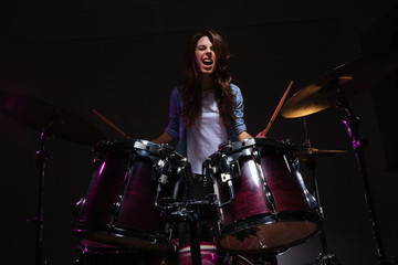 Fototapeta na wymiar Woman playing the drums
