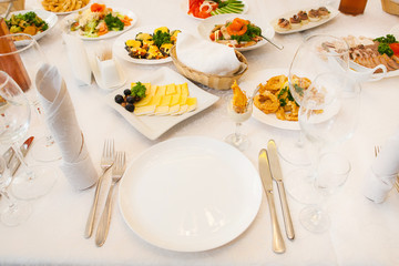 Table served with different food and flatware. Beautiful table ready for guests.