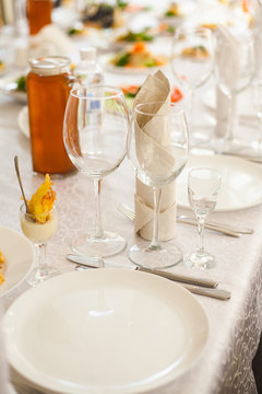 Table served with different food and flatware. Beautiful table ready for guests. Vertical color image.