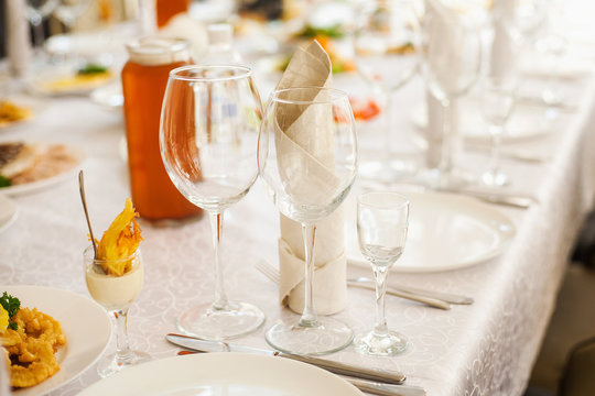 Table served with different food and flatware. Beautiful table ready for guests. Horizontal colour photo