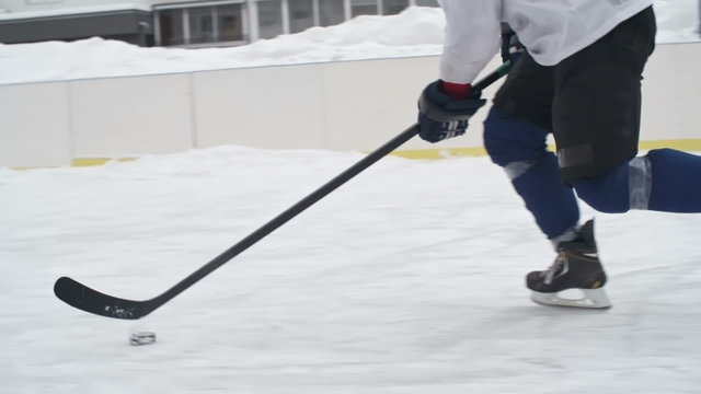Tracking shot of hockey player carrying the puck and losing it to an opponent 