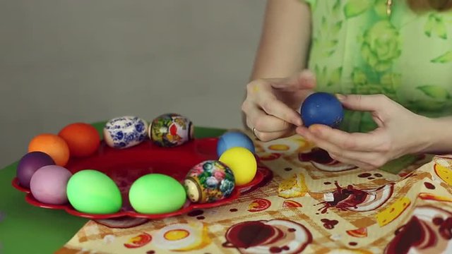 Preparation of Easter eggs, the feast of the passover, girl sticks decorative stickers on the Easter eggs
