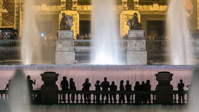 Famous light show and magic fountains timelapse in front of the National Art Museum at Placa Espanya in Barcelona at night, Catalonia, Spain